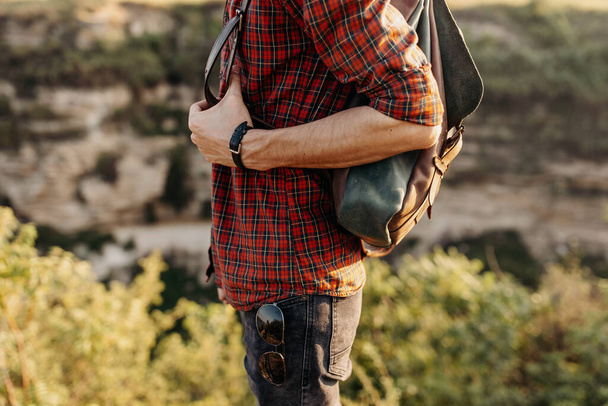 cropped shot of man with leather backpack on nature - Foto, Imagen