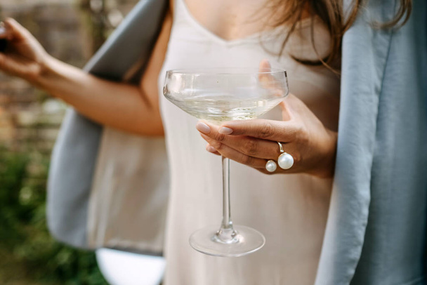 cropped shot of woman holding glass of alcohol cocktail drink - Photo, Image