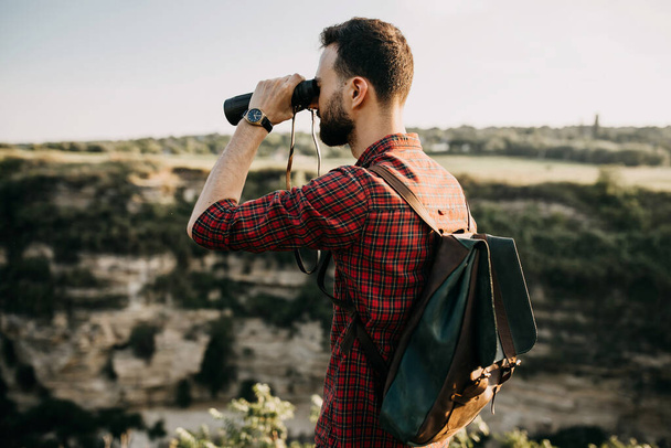 portrait of handsome young man with leather backpack on nature - Φωτογραφία, εικόνα