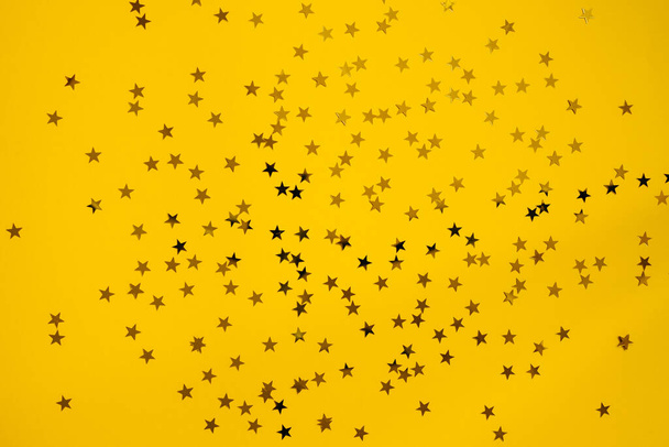 close-up shot of golden stars on yellow background - Photo, Image