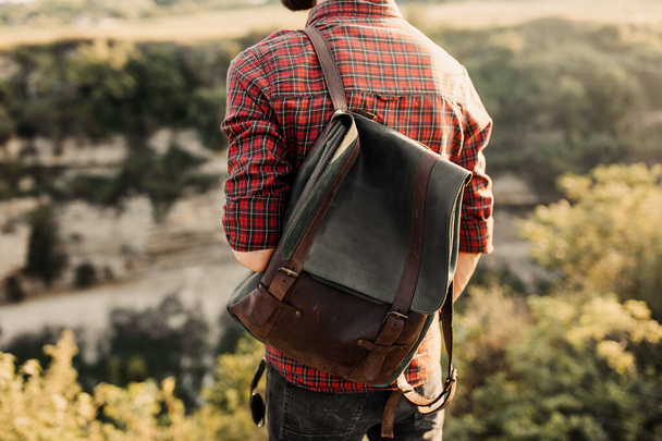 cropped shot of man with leather backpack on nature - Valokuva, kuva