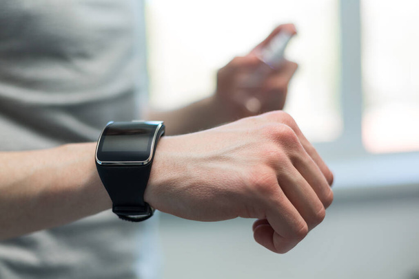 smart watch on the hand of a young man. - Photo, Image