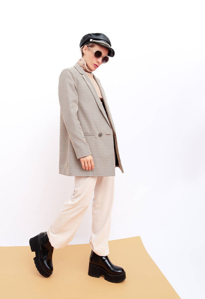 Stylish vintage Model. Details of everyday look. Casual beige outfit. Trendy Minimalistic style. Total Beige retro aesthetics. Fashion fall winter spring look book. - 写真・画像