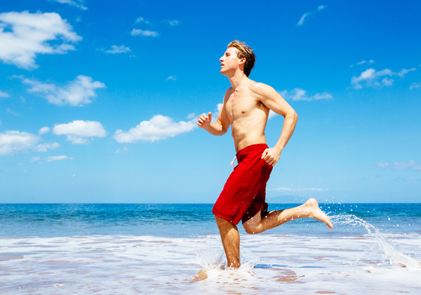 Athletic Man Running on Beach - Foto, imagen