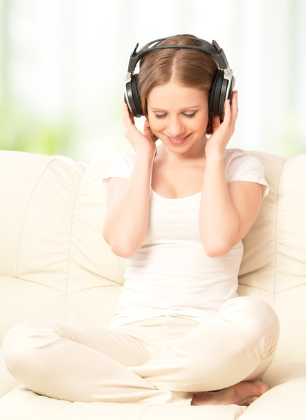 beautiful girl in headphones enjoying music at home  - Photo, Image