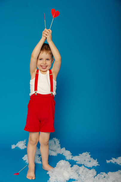 Little cute boy in red suspenders on Valentine's Day - Фото, изображение