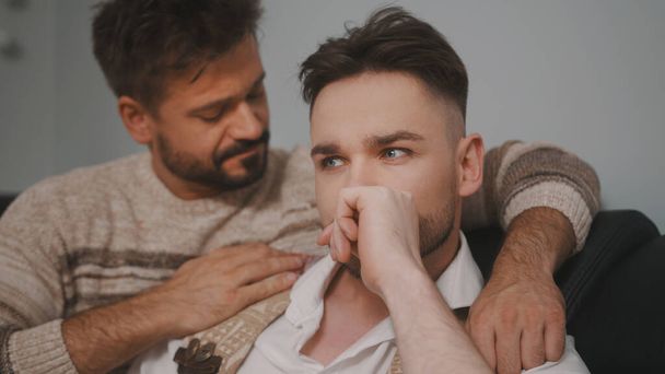 Bad news. Man calming down his almost crying partner - Valokuva, kuva