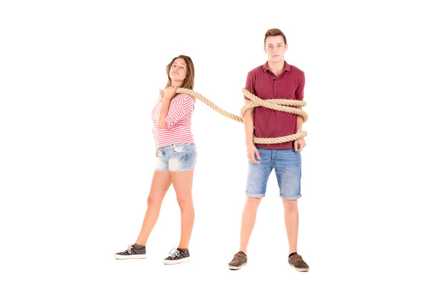 young couple fighting with rope isolated in white - Foto, Imagen