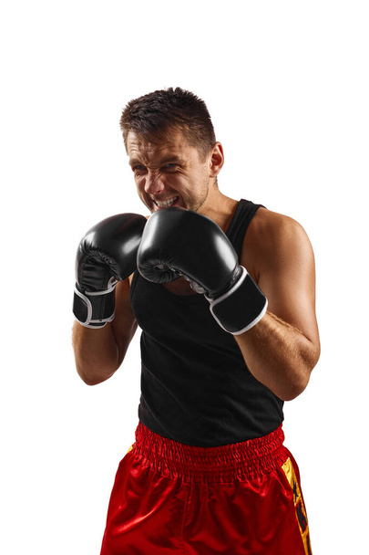 sporty man in black boxing gloves punching - Фото, зображення