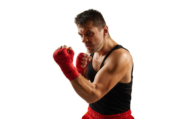sporty man in red sports bandages on his hands fighting - Фото, изображение