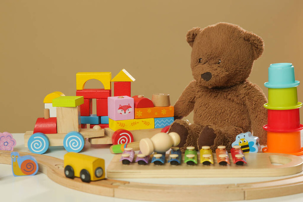 Colorful cildren's toys on table, wooden, plastic and plush toys - Photo, Image