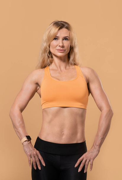 Nice muscular body of middle aged lady and workout - Zdjęcie, obraz