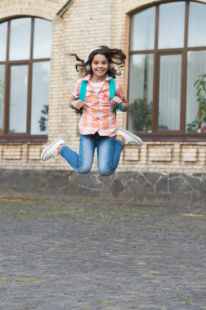 Happy childrens day. Energetic child jump in schoolyard. School education. International childrens day. November 20. Happy childhood leading to secure future - Photo, image