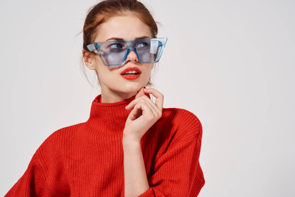 emotional woman with blue glasses on her face bright makeup red sweater - Photo, Image