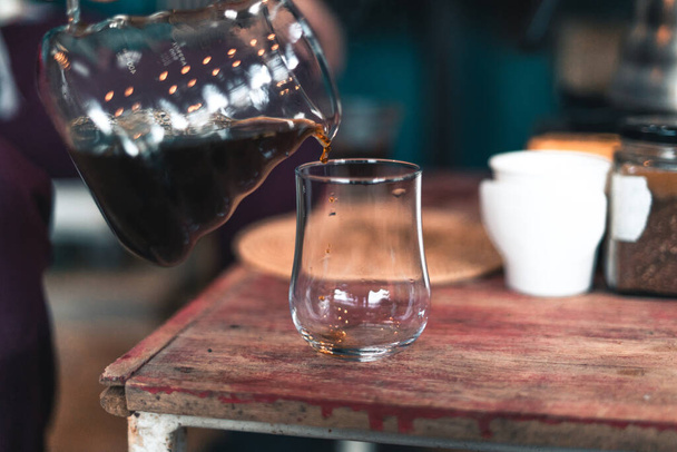 Caffè gocciolante, barista versando acqua sul fondo del caffè con filtro, fermentando caffè - Foto, immagini