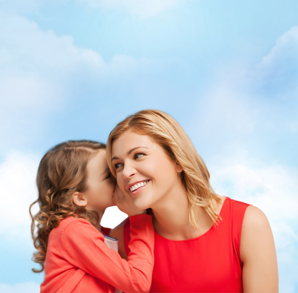 Smiling mother and daughter whispering gossip - Photo, Image