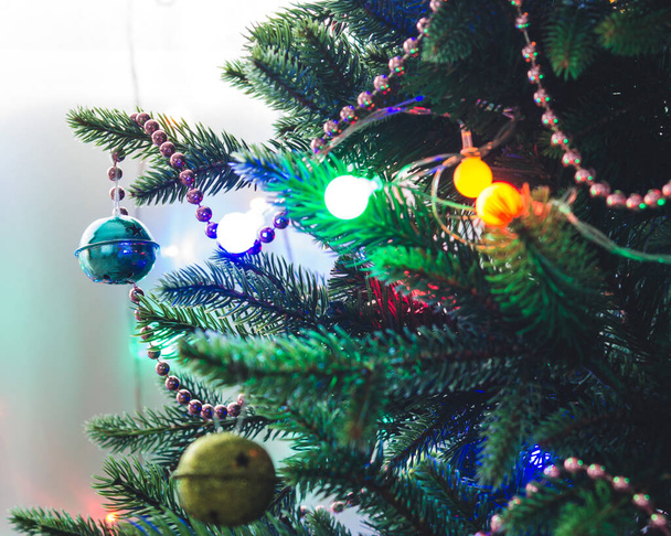 Christmas background - baubles and branch of artificial spruce tree - Photo, image