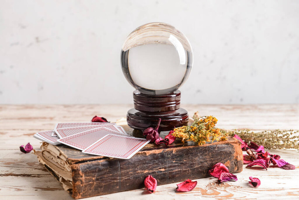Spell book, crystal ball and cards on wooden table - Foto, Imagem