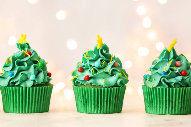 Tasty Christmas cupcakes on table - Valokuva, kuva