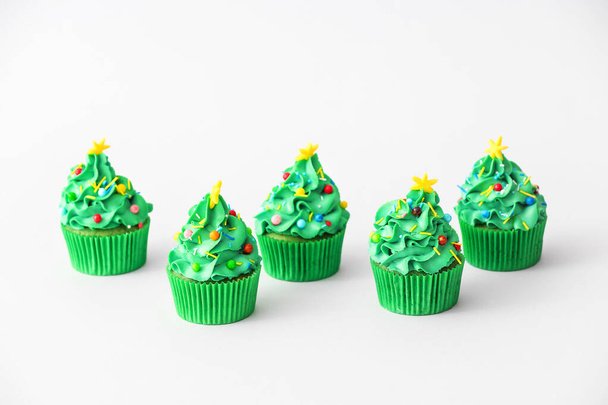 Tasty Christmas cupcakes on light background - Photo, Image