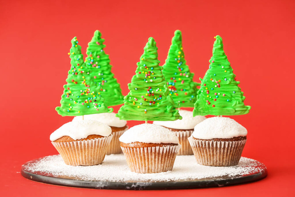 Tasty Christmas cupcakes on color background - Photo, Image