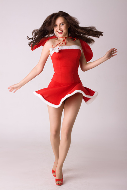 Very happy smiling woman in red xmas sexy costume - Photo, Image