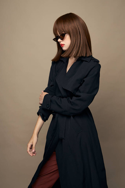 Attractive model dark coat good mood rejoicing studio  - Фото, зображення