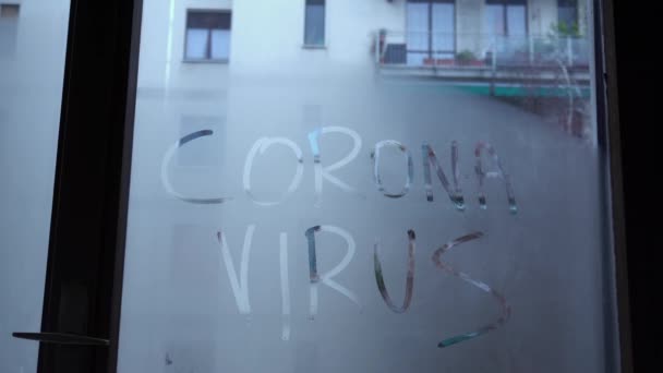 written Covid-19 Coronavirus on a fogged glass - hand erases the writing - concept of the end of the pandemic thanks to the arrival of the vaccine - Footage, Video