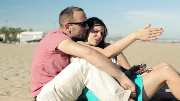 Couple relaxing on beach - Кадри, відео