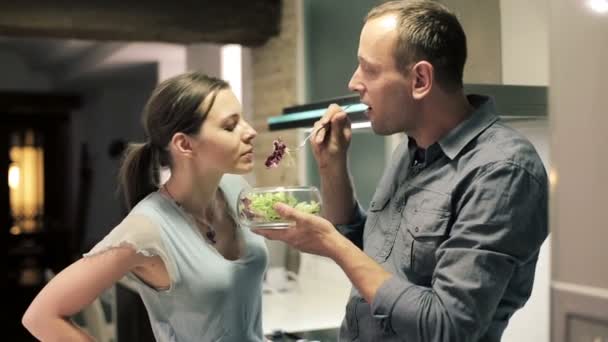 Couple eating, sharing salad - Felvétel, videó
