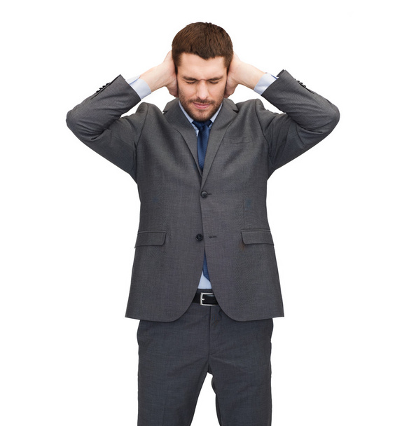 Annoyed businessman covering ears with his hands - Фото, изображение