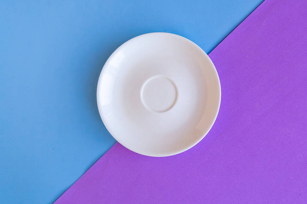 Empty plate on purple and blue background. Copy space for the text. Minimal concept - Photo, Image