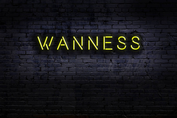 Panneau néon avec inscription "wanness" contre mur de briques. Vue de nuit - Photo, image