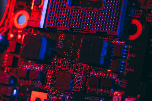 Processor socket in neon light. Motherboard with microchips. Dark photo.CPU processor. - Foto, Bild
