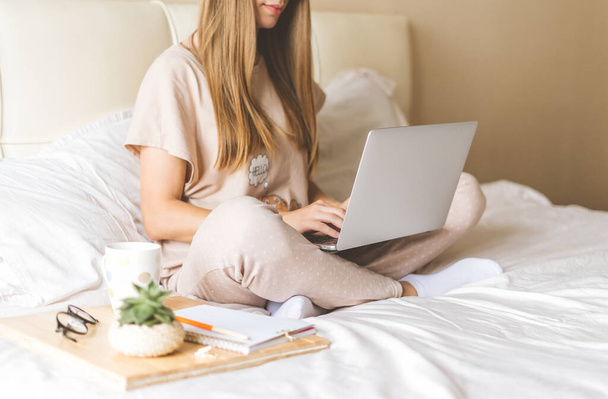 Blonde woman working at home with laptop - Photo, Image
