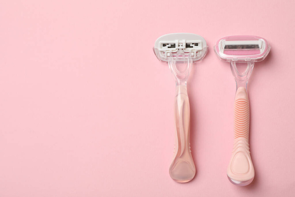 Dos navajas de afeitar sobre fondo rosa, espacio para texto - Foto, Imagen