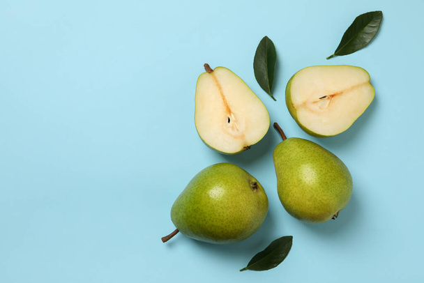 Fresh green pears on blue background, top view - Photo, image