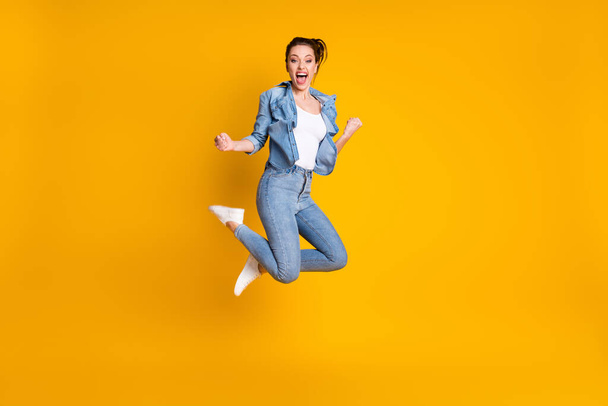 Full length body size view of her she attractive glad cheerful cheery funky girl jumping rejoicing having fun great news isolated bright vivid shine vibrant yellow color background - Foto, afbeelding