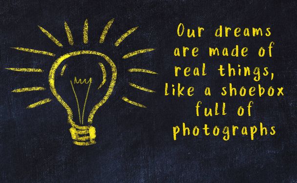 Wise quotation and a chalk drawing of a bulb on black chalkboard - Photo, Image