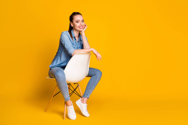 Full size photo of charming attractive girl sit chair enjoy rest relax wear look good outfit footwear isolated over shine color background - Foto, Imagen
