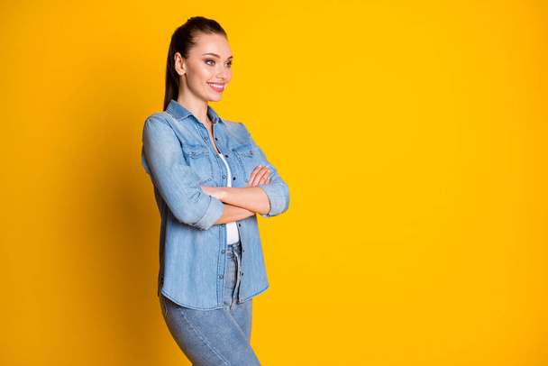 Turned photo of charming optimistic manager girl cross hands look copyspace listen colleagues decision wear denim clothes isolated over vivid color background - Foto, Bild