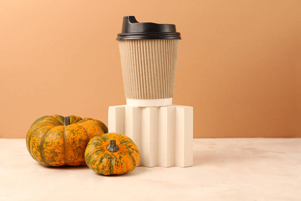 Assortment from pumpkins near geometrical podium with craft coffee cup.Concept of the spicy pumpkin coffee.Bold colors,copy space. - Photo, Image