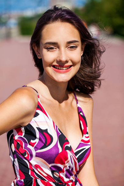 Portrait of a Young beautiful brunette girl in summer dress - Фото, зображення