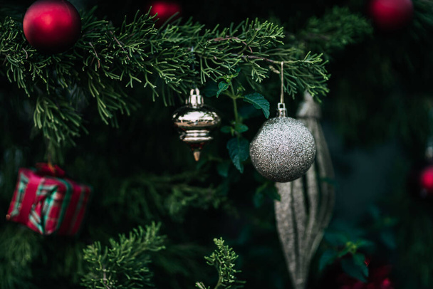 Merry x-mas,Close up of Colorful balls ,gifts box and Christmas greeting picture parcel decoration on Green Christmas tree background Decoration During Christmas and New Year. - 写真・画像