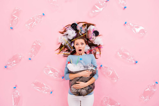 Top view above high angle flat lay flatlay lie concept of attractive stunned overwhelmed girl holding in hands junk global earth planet globe change decision isolated on pink pastel color background - Фото, зображення