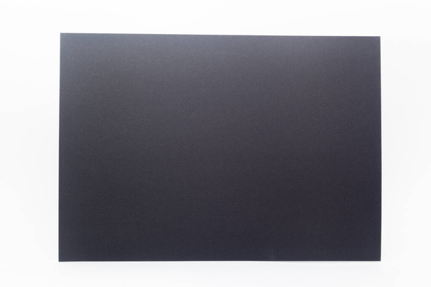 Primer plano de la hoja de papel negro sobre fondo blanco - Foto, imagen