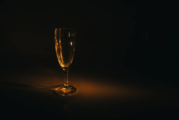 silhouette of a champagne glass on a dark background - Foto, imagen