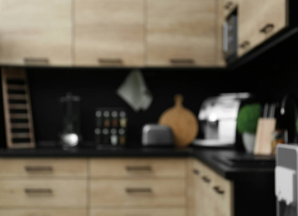 Blurred view of kitchen interior with modern furniture - 写真・画像