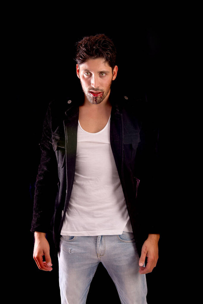 handsome vampire isolated in dark background - Fotó, kép