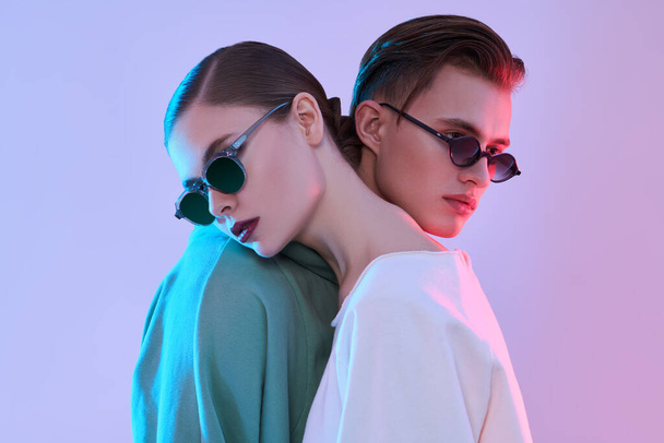 Couple of modern young people posing in stylish sunglasses. Glasses fashion. - Φωτογραφία, εικόνα